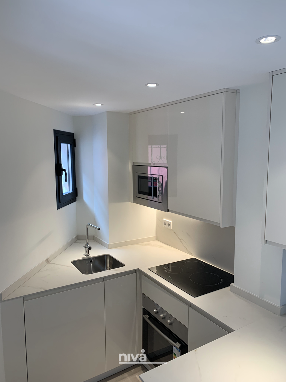 Cocina y electrodomésticos aprovechando todo el espacio disponible en reforma de apartamento en Estepona